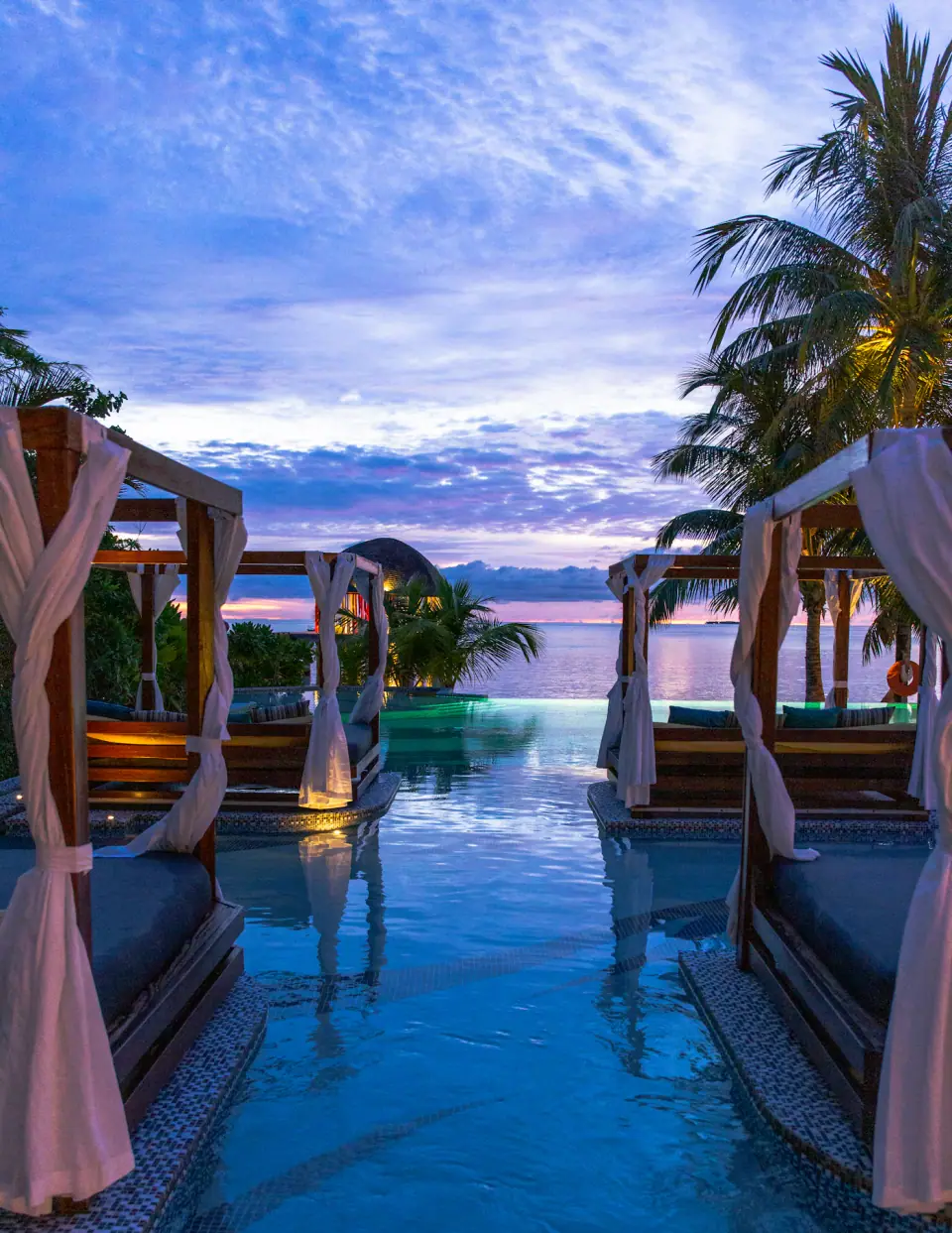Poolside cabanas at dusk