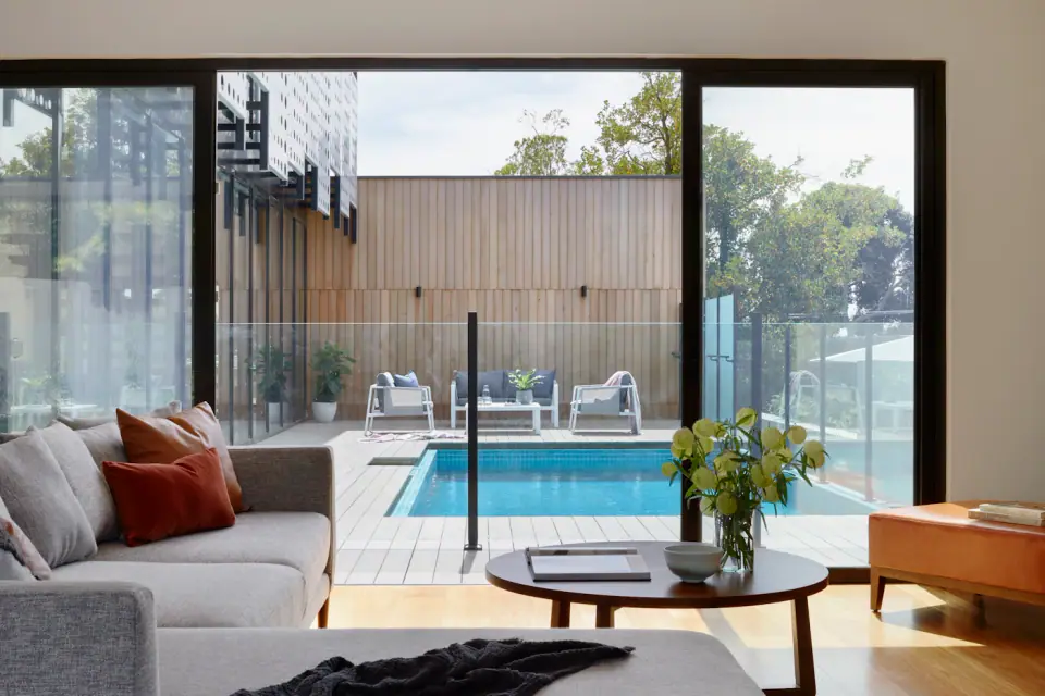 Living room opening to a pool terrace